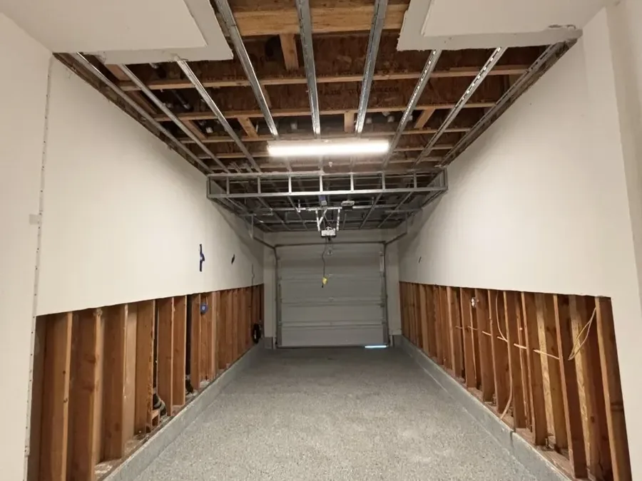 Garage walls and ceiling opened to expose structural framing