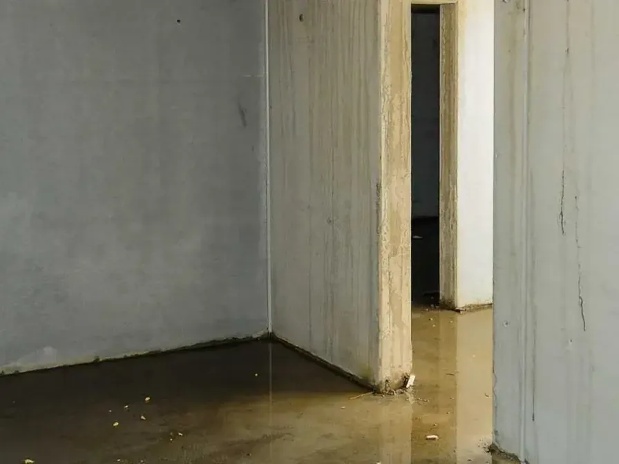 Standing water collected along block basement walls